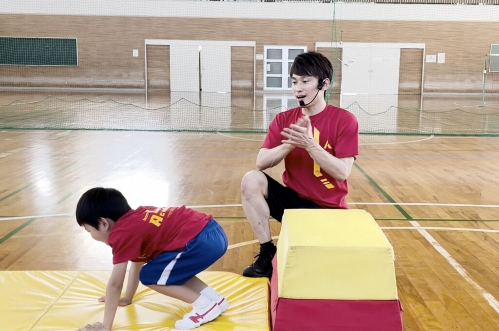 福井市教室にて、跳び箱が初めて跳べて時の子供と、拍手する大久保先生